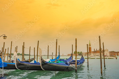 Obraz na płótnie Gondolas near Saint Mark Square (Piazza San Marco) and church of San Giorgio di Maggiore in the background, in Venice, Italy, at sunrise w salonie
