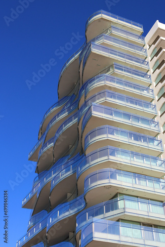 Low angle view of modern building against clear blue sky in Tróia, Portugal