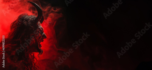 Angry devil profile with copy space for text - black background - yelling, shouting, screaming - god of evil - hell concept art - Leviathan, Astaroth, Mammon, Baal photo