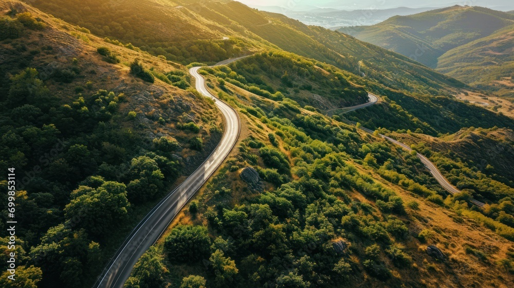 Aerial view of a winding mountain road, scenic drive, natural landscape.