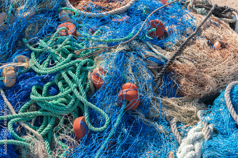 Industrial Fishing Equipment Fishnets and Fishing Lines lying on concrete in the port Industrial Fishing Equipment Fishnets and Fishing Lines lying on concrete in the port
