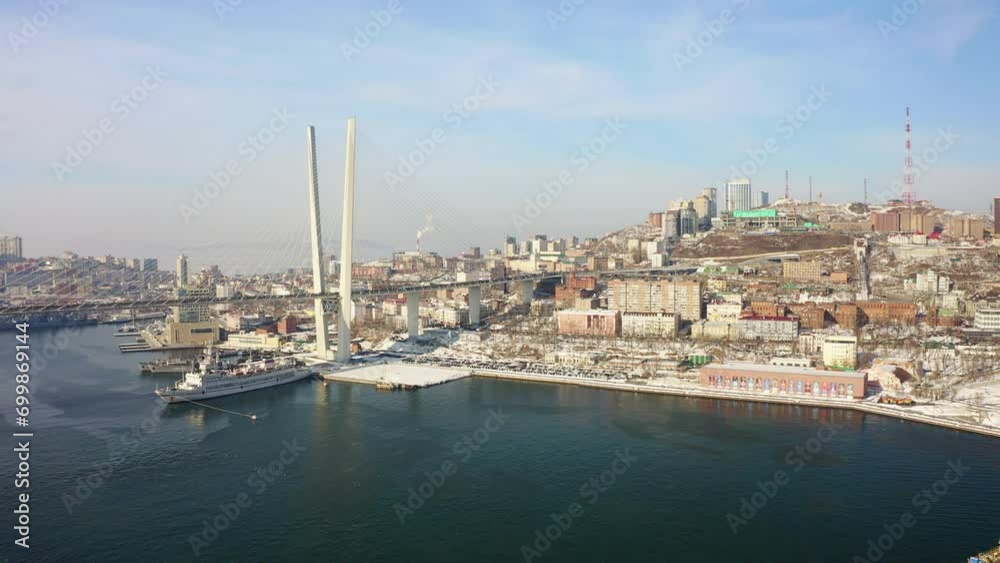 Aerial view of the Golden Bridge in Vladivostok and embankment in winter Aerial view of the Golden Bridge in Vladivostok and embankment in winter