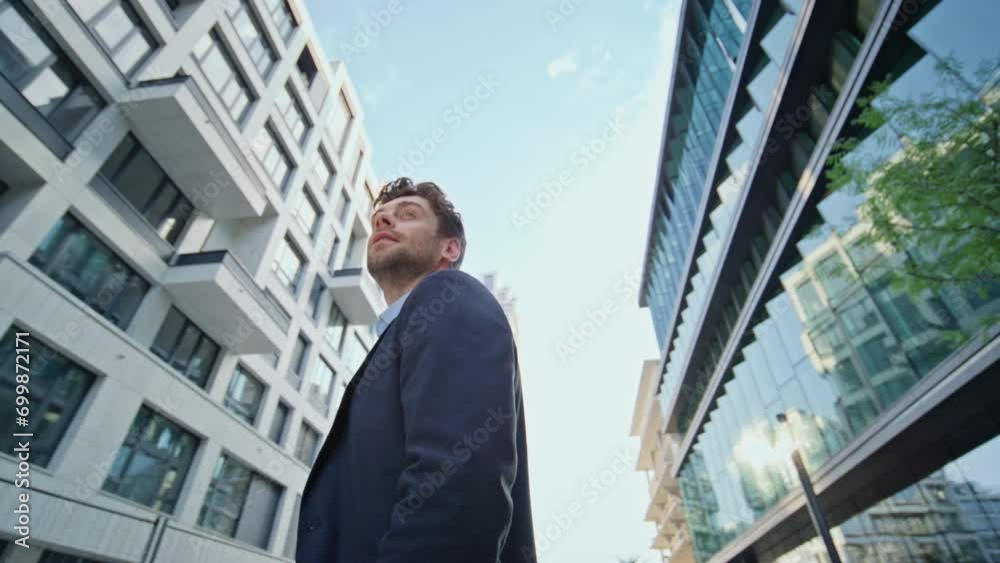 Successful manager standing urban district looking around. Businessman posing Successful manager standing urban district looking around. Businessman posing