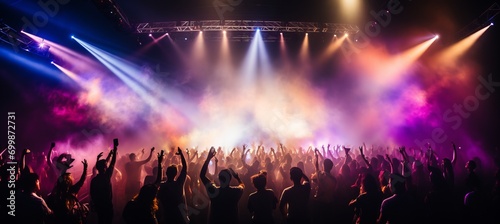 Dynamic and energetic concert stage with vibrant bokeh lights and blurred crowd in the background photo