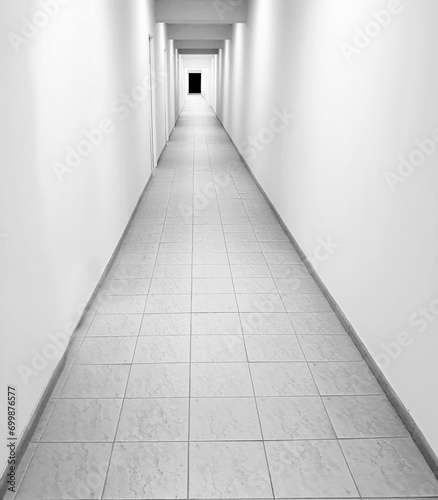 a long corridor stretching to a point on a black and white background