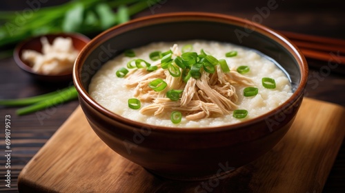 Bowl of chicken congee garnished with green onions photo