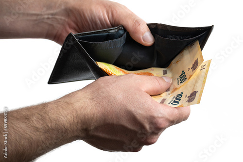 Hand with wallet and Argentine bills