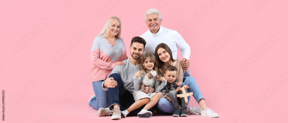 Portrait of big family on pink background