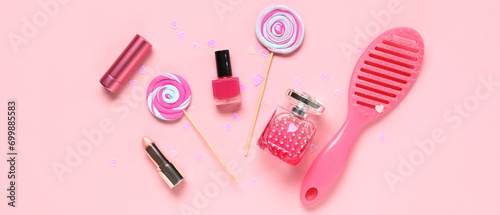 Set of female accessories with lollipops and confetti on pink background