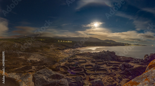 Noche de luna llena sobre castro de Baroña en Porto do Son A Coruña Galicia España photo