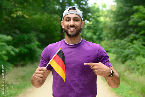 Young man pointing at flag ...