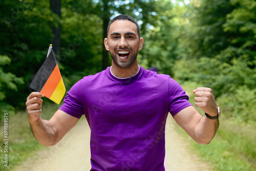 Happy young man with flag o...