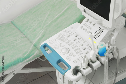 Ultrasound control panel and examination table in hospital, closeup