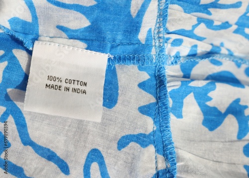 Clothing label on color garment, closeup view © New Africa
