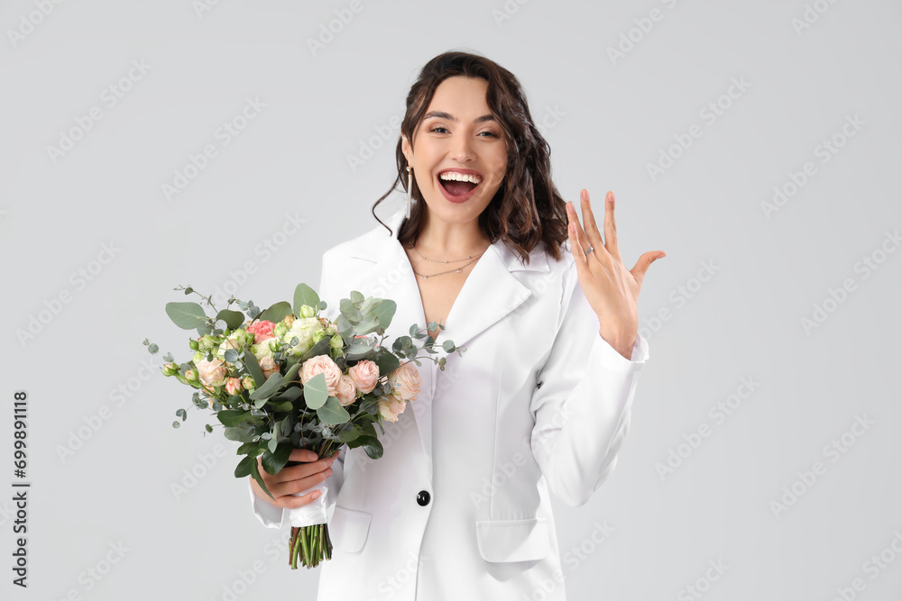 Beautiful bride with wedding bouquet on light background Beautiful bride with wedding bouquet on light background