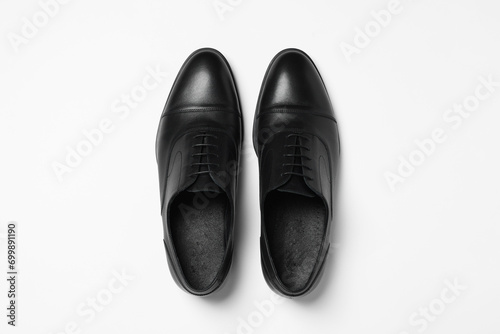 Pair of leather men shoes on white background, top view