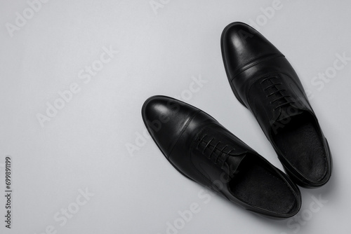 Pair of leather men shoes on white background  top view. Space for text