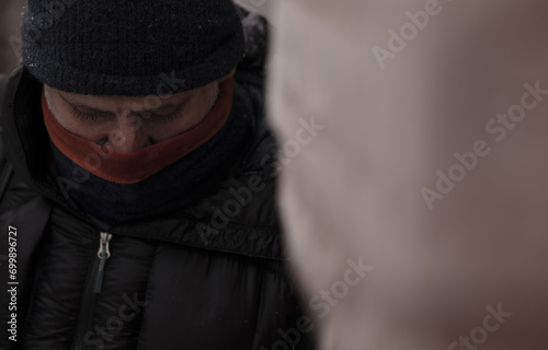 Portrait of adult man in winter clothes with snow