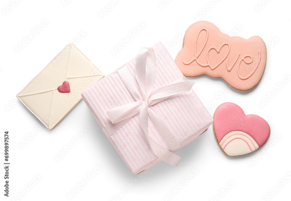Sweet cookies with gift for Valentine's Day celebration on white background Sweet cookies with gift for Valentine's Day celebration on white background