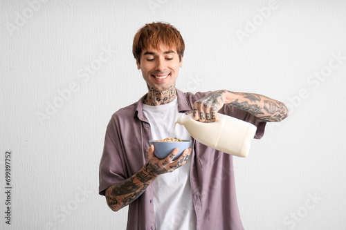 Man pouring milk into bowl ...