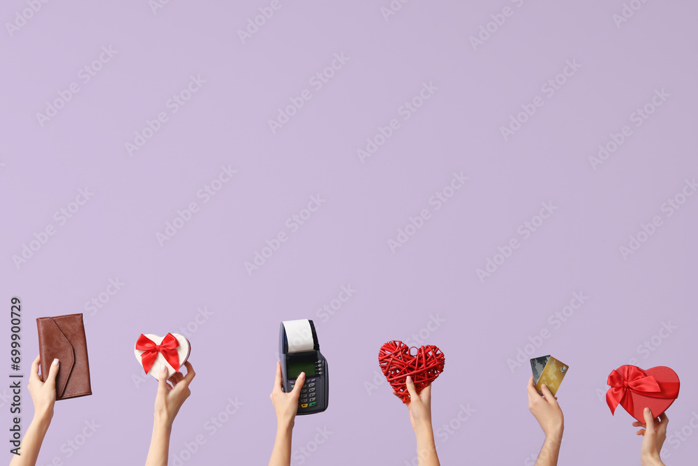 Women with wallet, gifts, payment terminal and credit cards on lilac background. Valentine's Day celebration