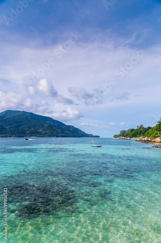Beautiful Andaman sea, Tropical Turquoise clear blue sea and blue sky background at Lipe Island, Satun, Thailand -  summer  vacation travel © lukyeee_nuttawut