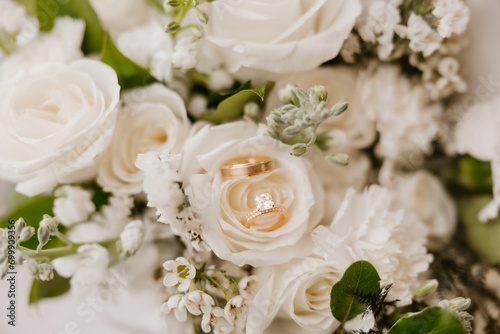 Graceful wedding moment: Wedding Rings with stunning white floral bouquet. © Mariah