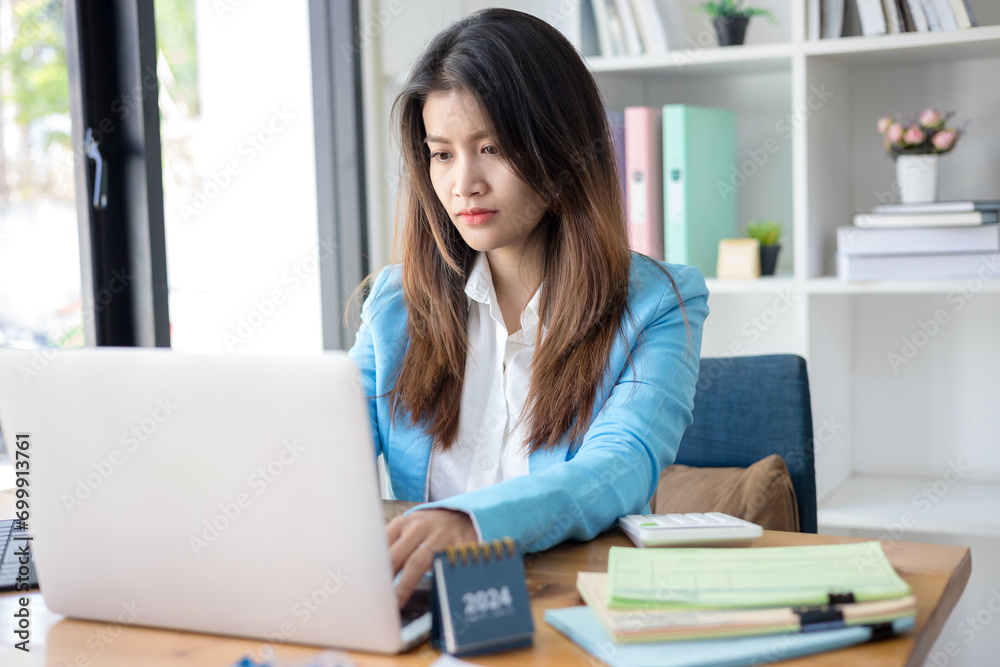 Business woman working in office with documents and laptop. Business concept Business woman working in office with documents and laptop. Business concept