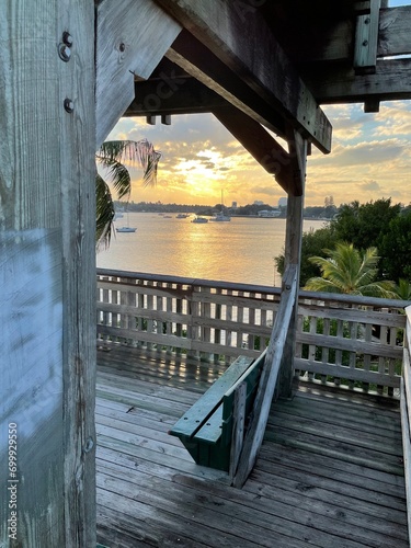 Sitting on the porch of a beach hut looking at the sunset over the ocean
