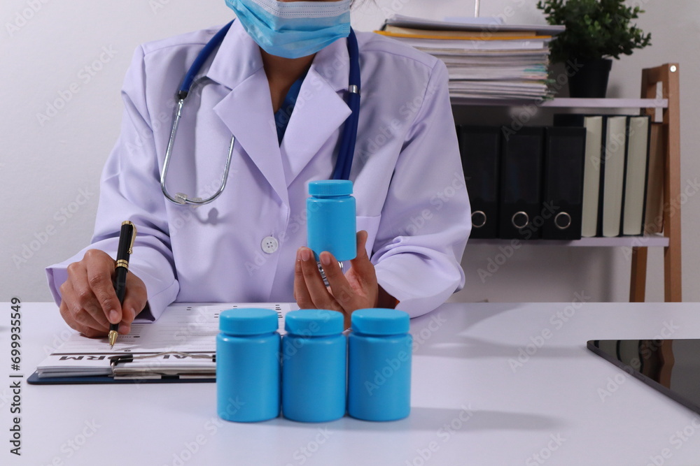 Close up of the ears of a professional female doctor in uniform taking notes in a notebook Medical therapist filling out medical documents. Clipboard. Patient form. Illness history, prescription Close up of the ears of a professional female doctor in uniform taking notes in a notebook Medical therapist filling out medical documents. Clipboard. Patient form. Illness history, prescription