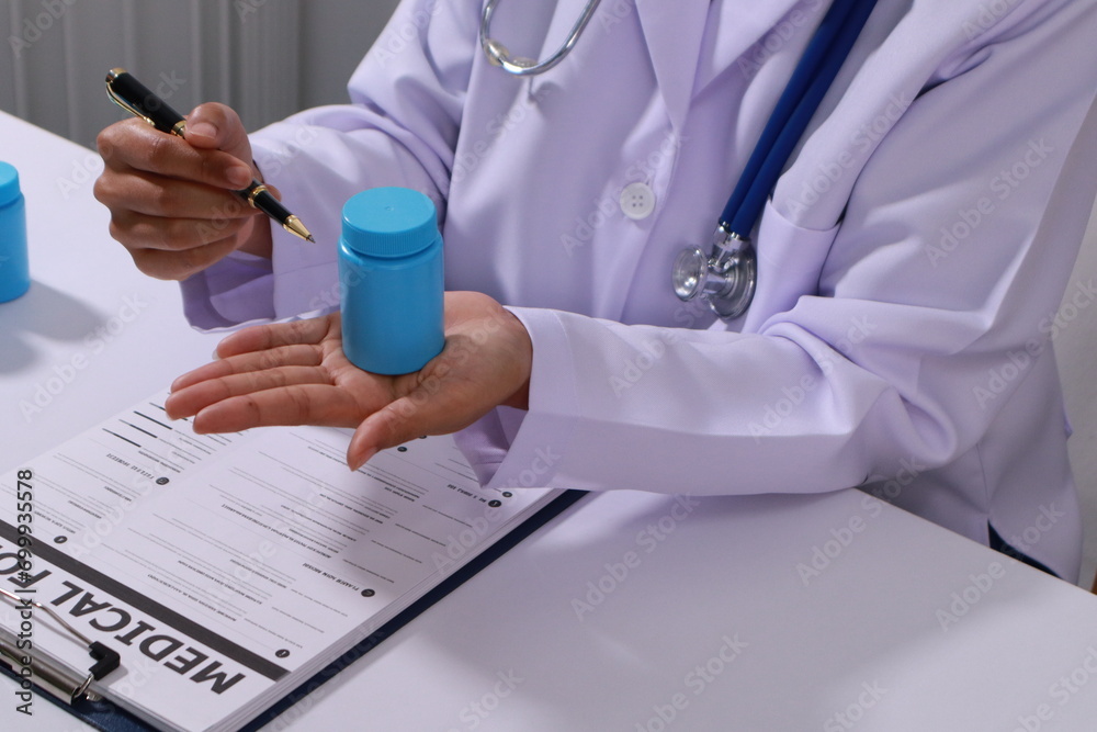 Fototapeta premium Close up of the ears of a professional female doctor in uniform taking notes in a notebook Medical therapist filling out medical documents. Clipboard. Patient form. Illness history, prescription