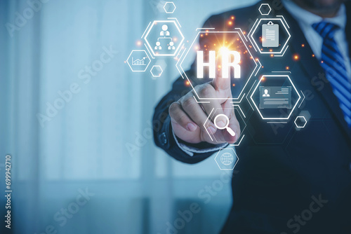 The human resource manager touching HR is recruiting employees for choose the perfect employee for his business. The human resources system digital and online. Interview, recruitment concept.