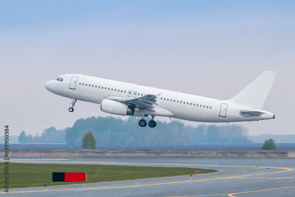 Take off of a white passenger aircraft on the runway Take off of a white passenger aircraft on the runway