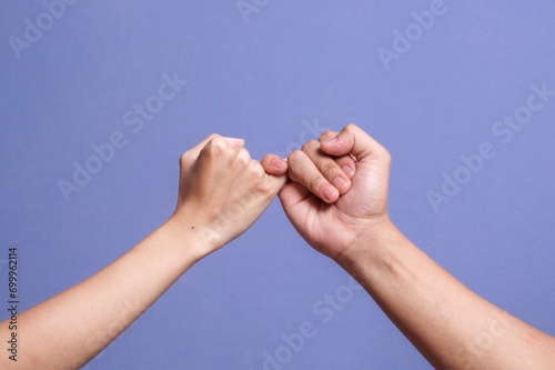 Pinky promise hands gesturing. Concept of reconciliation of friends or lovers. photo