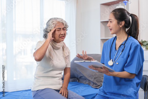Fotografía Health check concept, Elderly Asian woman with grey hair, sitting and talking to young Asian nurse by appointment, sitting on medical bed
