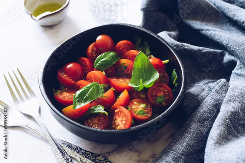 Healthy salad with cherry tomatoes and basil 