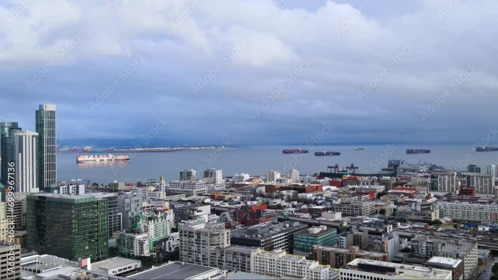 Panoramic aerial of San Francisco city skyline buildings, South Beach Harbour Bay ferry pier and industrial ships in background under stormy sky, CA, USA Panoramic aerial of San Francisco city skyline buildings, South Beach Harbour Bay ferry pier and industrial ships in background under stormy sky, CA, USA