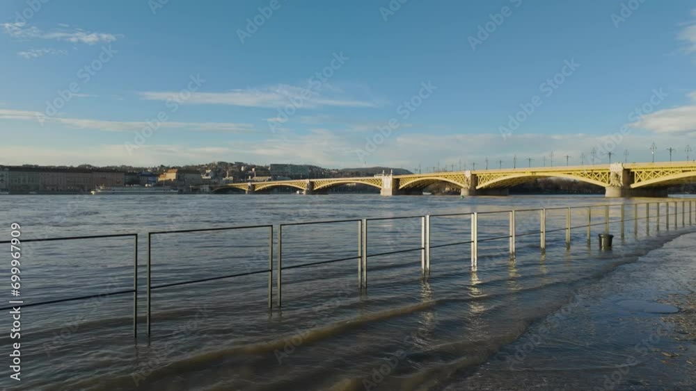 Wide shot of the flooding Danube River and Margaret Bridge in the Background at Budapest, Hungary - December 2023 Wide shot of the flooding Danube River and Margaret Bridge in the Background at Budapest, Hungary - December 2023