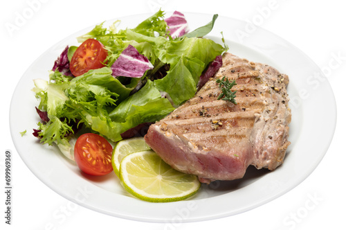 grilled cooked piece of tuna fillet on ceramic plate isolated
