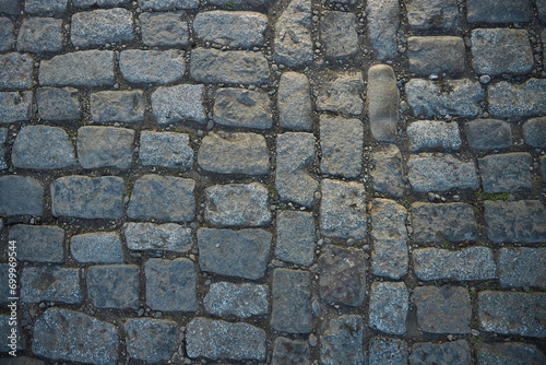 The texture of masonry on the street. Cobblestone, old elements in old cities