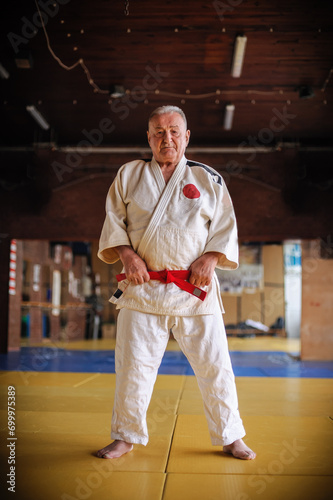 Respected and experienced judo sensei master instructor in traditional gi kimono. A skilled martial artist demonstrates his expertiset
