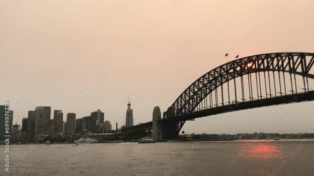 Sydney Harbour Bridge in a sunset time with smoke from bonfires. Sydney Harbour Bridge in a sunset time with smoke from bonfires.