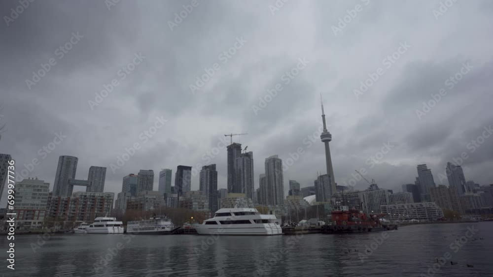 Yachts in water in foreground of Toronto skyline on cloudy day, static Yachts in water in foreground of Toronto skyline on cloudy day, static