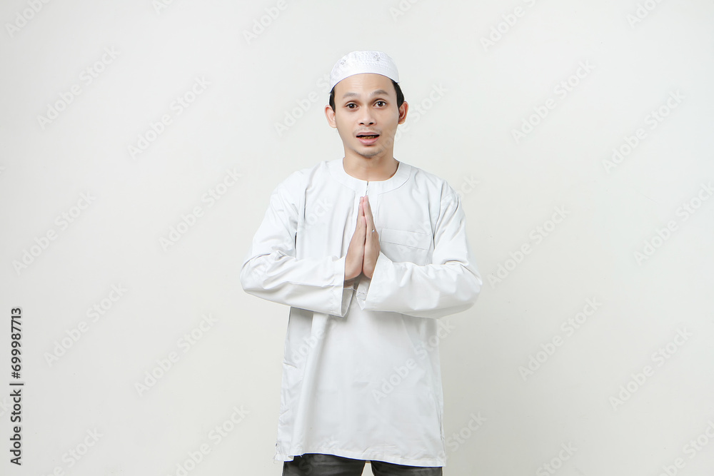 happy asian muslim man greeting gesture. People religious Islam lifestyle concept. celebration Ramadan and ied Mubarak. on isolated background.