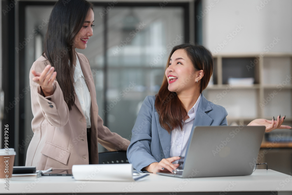 Two Asian businesswomen working together, meeting and discuss of new business project, professional people. Two Asian businesswomen working together, meeting and discuss of new business project, professional people.