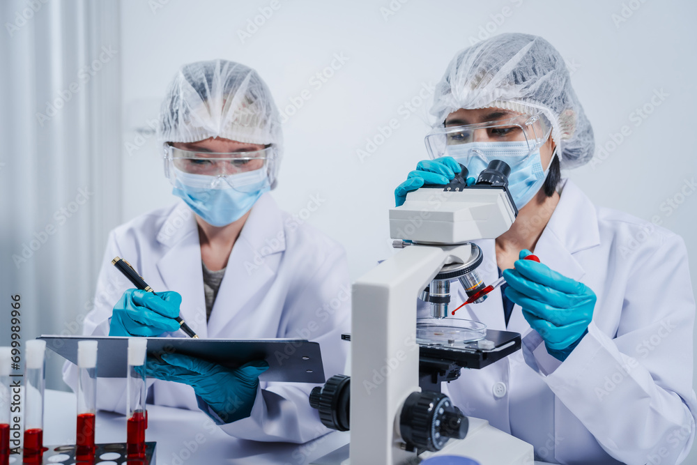Professional scientists in lab working with blood samples. to find components in blood Ideas for inventing and researching drugs and viruses in blood system. Professional scientists in lab working with blood samples. to find components in blood Ideas for inventing and researching drugs and viruses in blood system.