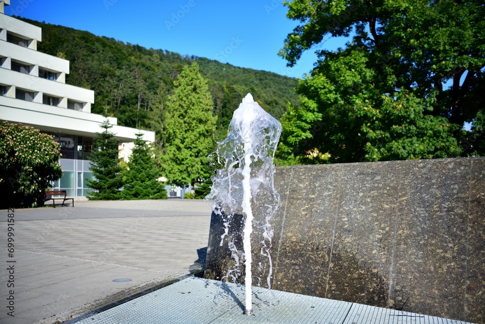 The high-flowing city fountain on the square in the city