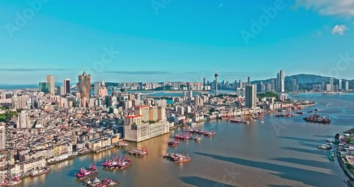 Aerial drone footage of city skyline with modern buildings scenery in Macau. Drone shooting forward. photo