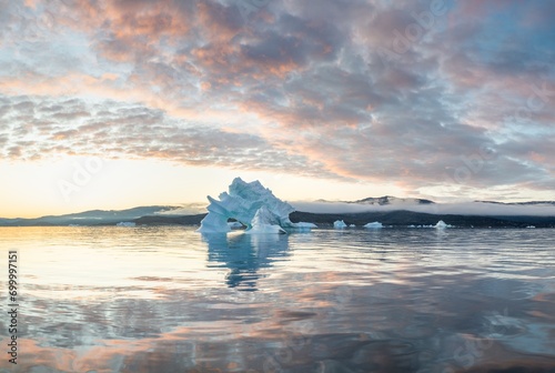 Melting icebergs by the coast of Greenland, on a beautiful summer day - Melting of a iceberg and pouring water into the sea. Global warming
Arctic nature landscape, Summer day