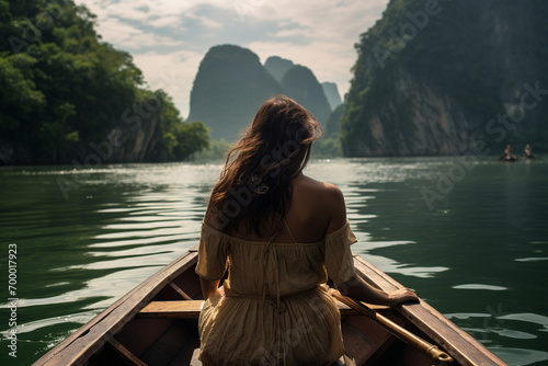 a woman sitting on a boat with mountain landscape bokeh style background